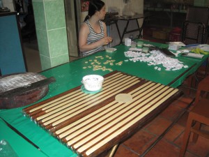 Kokos karameller blir kappes i biter og pakket for hånd.